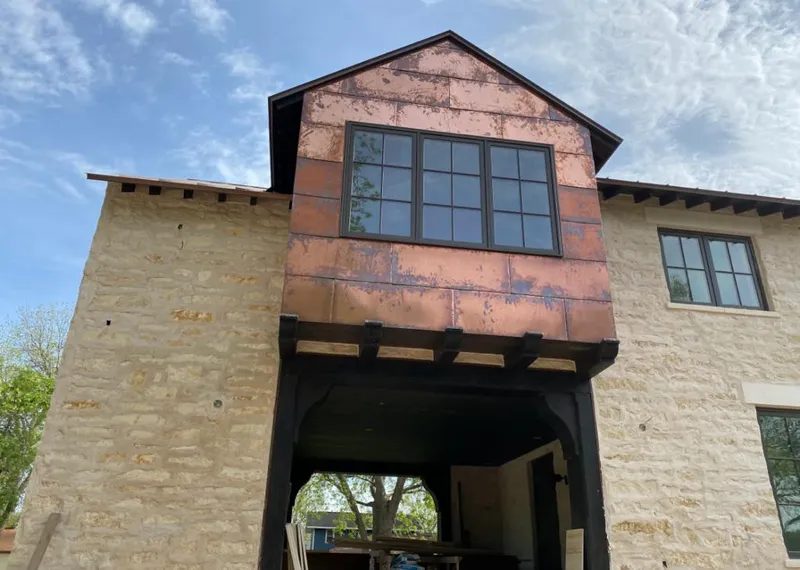 Copper metal panel facade on a stone building for Skylight Installation in Smithville