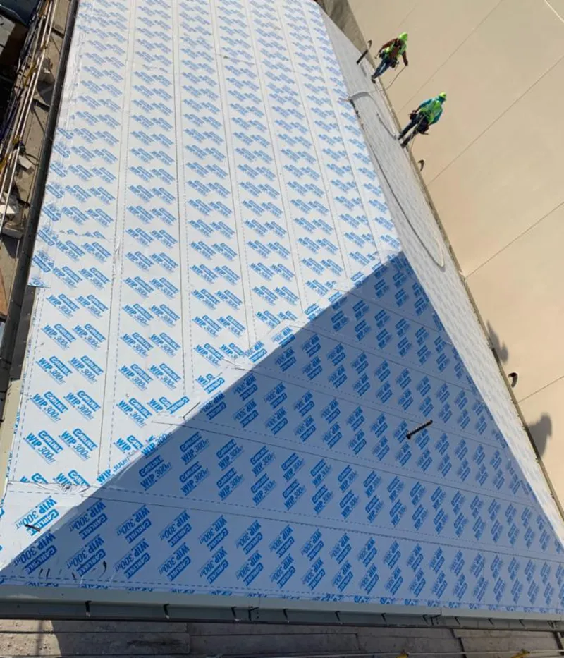 Professional roofers installing underlayment on a metal roof in Smithville